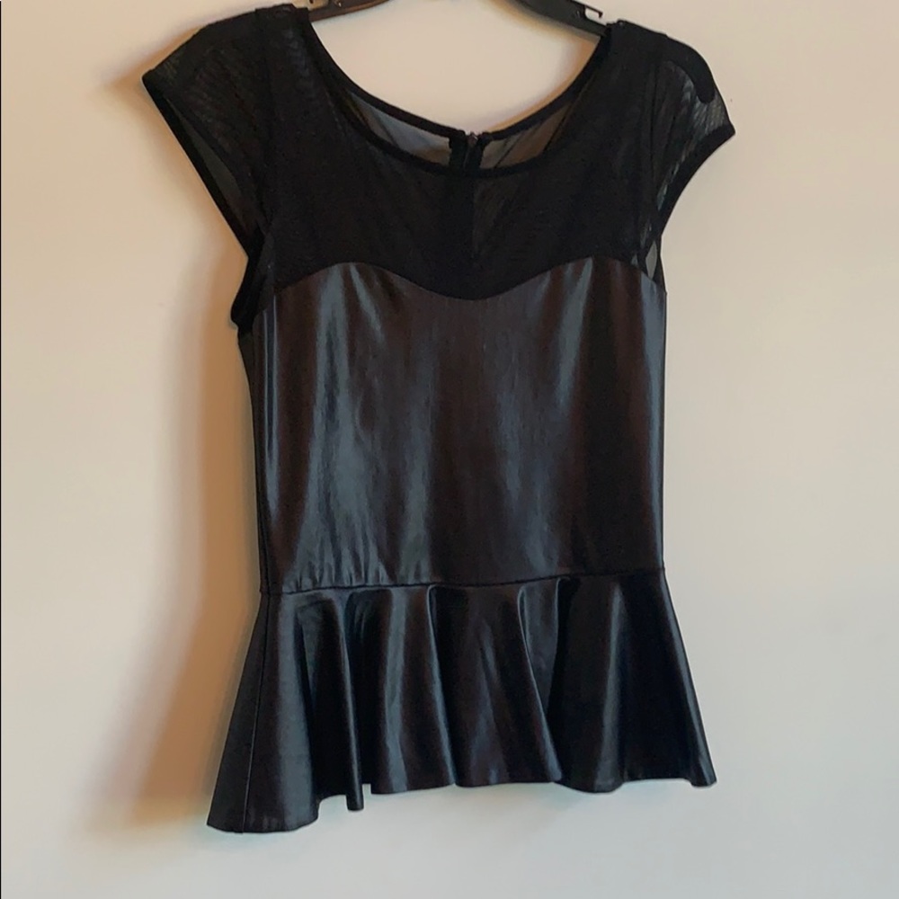 Peplum style top with back zipper.  By bebe